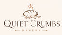 Logo of Quiet Crumbs Bakery with a loaf of bread and leaves on a white background